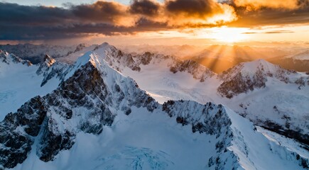 Cinematic wide-angle shot of a vast snowy mountain landscape at sunrise