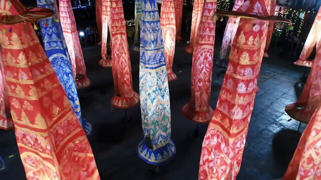 Colorful traditional Thai Lanna lanterns decoration with pattern design at night festival. Culture celebration with illuminated lanterns hanging. Festival background.