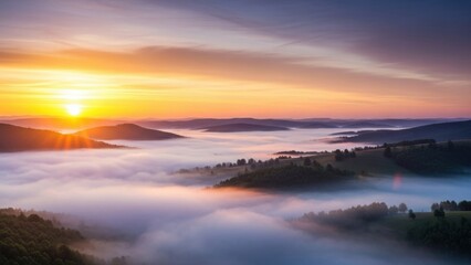 Fototapeta premium Golden sunrise over misty mountain valleys at dawn creating a breathtaking natural spectacle