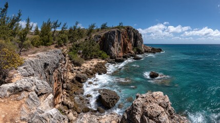 Coastal Panoramic View of Rocky Cliffs Edged with Green Bushes and Turquoise Sea Under a Partly Cloudy Sky Landscape