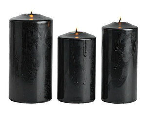 Three cylindrical black candles burn with tiny flames