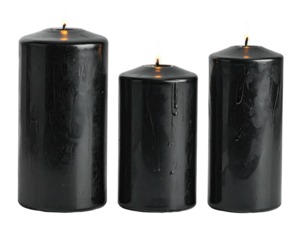 Three cylindrical black candles burn with tiny flames