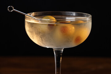 beautiful and dramatic lighting on a dirty martini with 3 olives