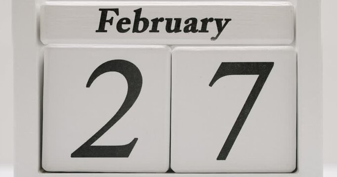 White wooden calendar block flipping through the days of February. Great for showing the passage of time, concepts of age, or as a visual for February events. February Calendar Page Flip