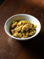 Thai stir fried chicken and bitter gourd with yellow curry