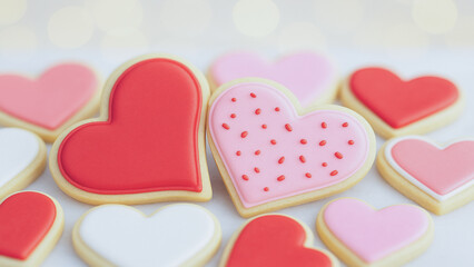 Fototapeta premium Valentine’s Day themed sugar cookies in heart shapes with pastel icing, representing romance, affection, and handmade treats.