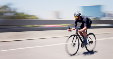 Athlete, man and speed on bicycle in city for cycling exercise, endurance challenge and motion blur. Space, fast and cyclist with bike in road for triathlon fitness, sports performance and training © EineroLens/peopleimages.com