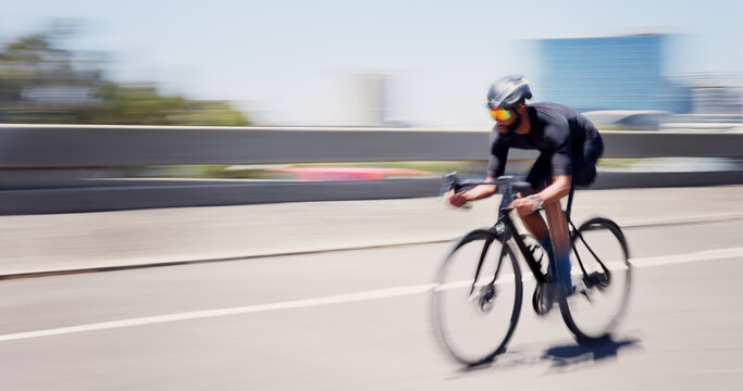 Athlete, man and speed on bicycle in city for cycling exercise, endurance challenge and motion blur. Space, fast and cyclist with bike in road for triathlon fitness, sports performance and training