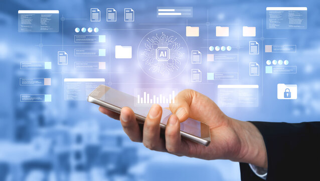 A business professional holds a smartphone displaying a digital interface focused on artificial intelligence and data analytics, highlighting modern technological applications. Gantry - Powered by Adobe