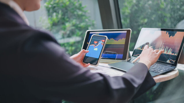 Investor analyzing financial data on multiple devices for market analysis - Powered by Adobe