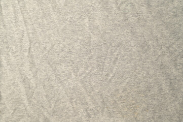 High-resolution.Top view of a light gray heathered fabric, likely a jersey knit used for t-shirts or activewear.