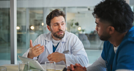 Meeting, tablet and nurses with doctors in office for medical case review, treatment plan or research. Patient history, online healthcare result and team with people talking for clinic report