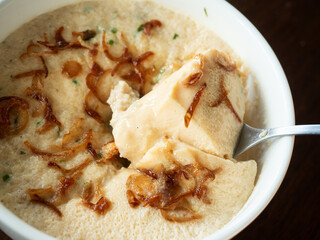 scooping steamed egg with crispy shallot