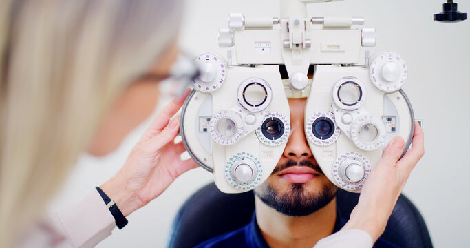 Optometrist, client or man with phoropter for eye exam, vision test or determine prescription for clear sight. Assessment, optometry or people with lens selection machine, consultation or clinic