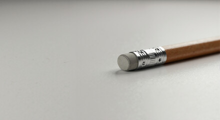Obraz premium Close up of a wooden pencil eraser on a light background. Concept of correcting mistakes and editing. Copy space for text