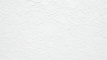 Close-up of a textured white surface resembling crumpled paper or plaster