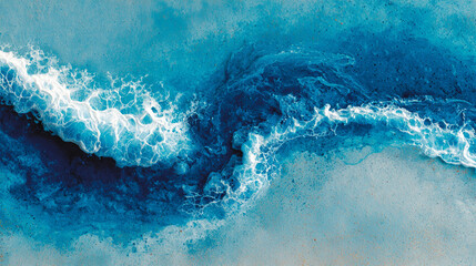Aerial view of ocean waves crashing with white foam on a blue surface.
