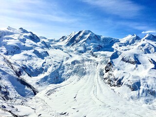 Spectacular panoramic view of the Gornergrat glacier and snow-covered mountain peaks in the Swiss Alps near Zermatt, Switzerland.