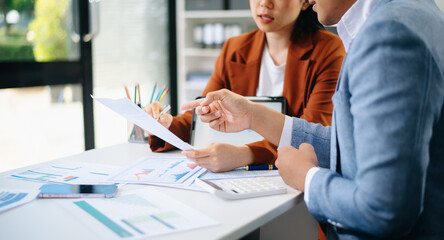 Business team collaboration discussing working analyzing with financial data and marketing growth report graph in team, presentation and digital tablet, laptop.