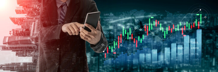 Fototapeta premium A businessman is analyzing financial data on his smartphone while reviewing stock market graphs in a modern office setting. Data overlay depicts market trends. Scalp