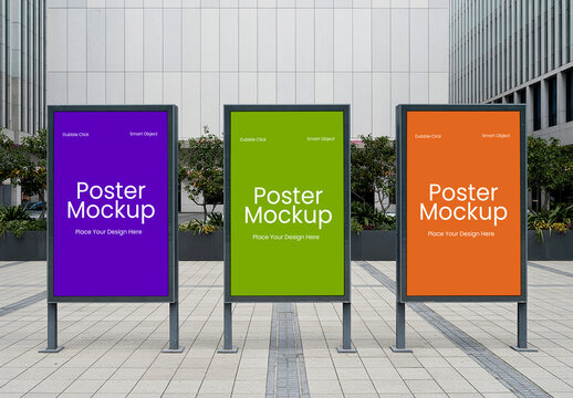 Three Vertical Poster Kiosk Mockups in City Plaza