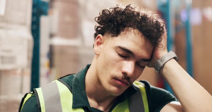 Frustrated man, logistics and headache with stress in warehouse for supply chain fail or mistake. Tired, male person or distributor with migraine, fatigue or burnout for overworked strain in depot