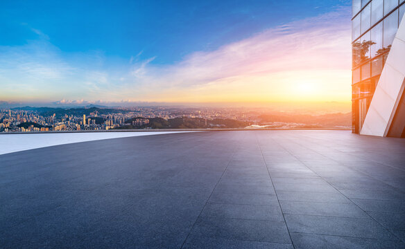 Empty square floor and modern city skyline with residential buildings at sunset in Shenzhen