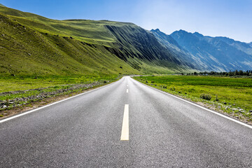 Empty asphalt road and green mountain natural landscape under blue sky