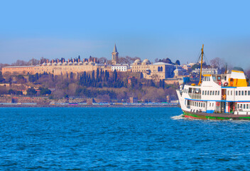 Famous historical peninsula of Istanbul with crescent moon - Hagia sophia, Sultanahmet Mosque - Istanbul, Turkey - Water trail foaming behind a passenger ferry boat - Bosphorus, Istanbul