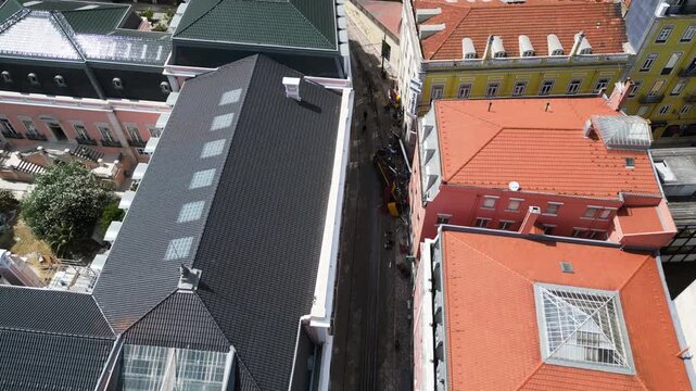 Aerial view tilting away from the Gloria Funicular tram crash site in Lisbon