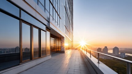 Contemporary business building with full glass curtain wall facade during sunset, urban skyline background. 