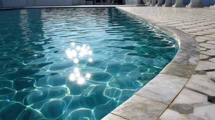 Shimmering aqua pool water with delicate ripples, illuminated by morning sun and featuring elegant marble mosaic tiles. 