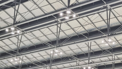 A photograph of the roof structure of a passenger waiting area at an airport in Thailand.
