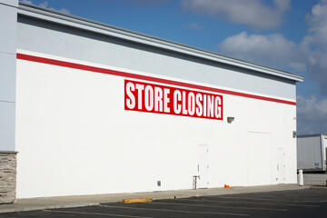 Store closing sign on building