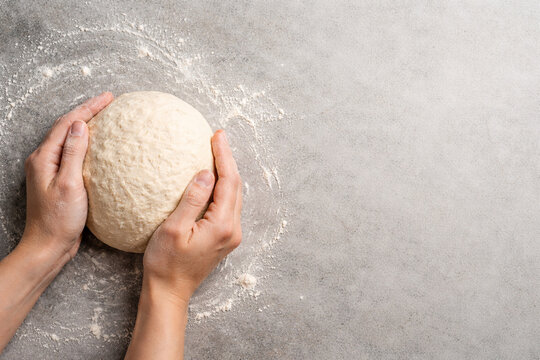 Process of kneading and shaping homemade yeast dough, artisan bakery.