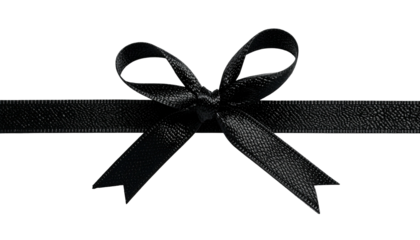 Close-up of a black satin ribbon tied into a delicate bow on a dark background