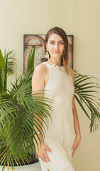 The portrait of beautiful brunette woman closeup on the green natural background with decorations. bali, indonesia