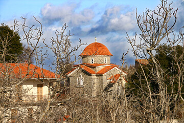 Stone Church in Valtesiniko Village Among Bare Branches, Arcadia, Greece