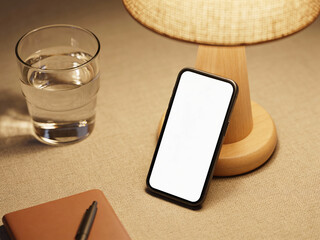 Minimal phone on desk with lamp and glass blank screen mockup for mobile UI showcase