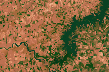 Fototapeta premium Aerial view of a river winding through a landscape with varying vegetation