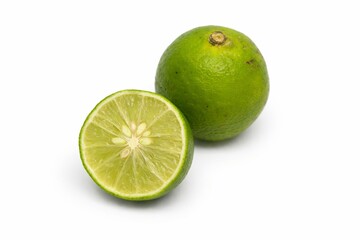 Fresh Green Lime Whole and Sliced Half Isolated on White Background