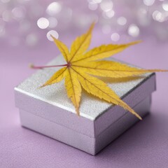 Silver Gift Box With Yellow Maple Leaf On Purple Background