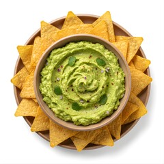 Guacamole (avocado dip with lime, onion, and cilantro) served with tortilla chips in ceramic bowls and plates