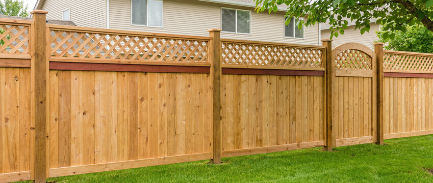 modern wooden fence in backyard with lattice design