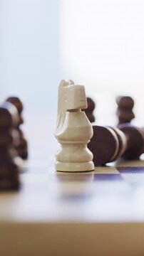 Hand, home and person with chess game, board and moving piece with victory. Contest, player and champion with strategy, checkmate and thinking with challenge, winning and competition with knight