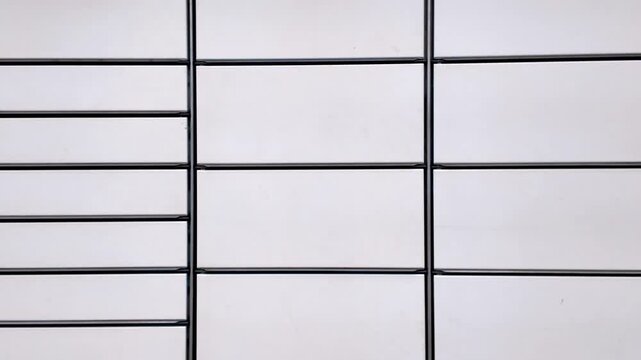 White metal parcel locker cabinets with geometric door pattern detail of modern urban infrastructure minimalist design