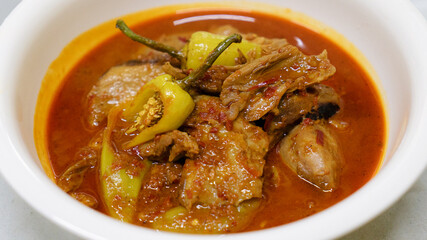 Spicy Asian pork curry in white bowl