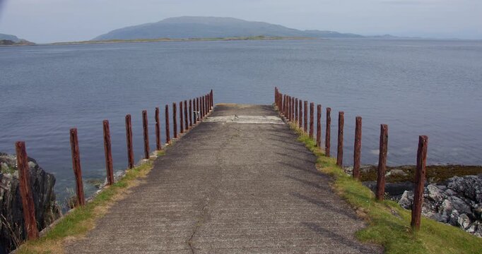 Show looking down a old disused jetty at Craignish Point, Sound of Jura.