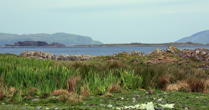 Shot looking across the rocky Shoreline of Craignish Point with the Sound of Jura with Islands of Reisa Mhic Phaidean , coiresa, and Scarba in background