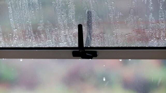 Rain drops falling on an open widow